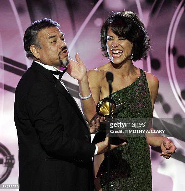 Los Angeles, UNITED STATES: Best Tejano Album winner Little Joe Y La Famila jokes with host Giselle Fernandez during the 48th Annual Grammy Awards...