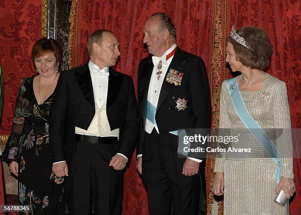 Russian President Vladimir Putin and his wife Lyudmila pose with Spain's King Juan Carlos and Queen Sofia at an official dinner in honour of Russian...