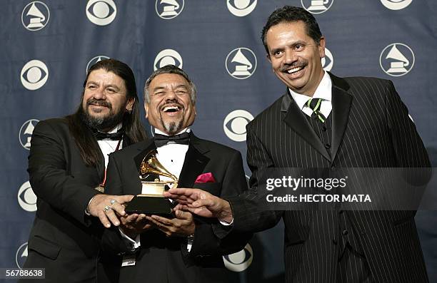 Los Angeles, UNITED STATES: Members of the group Little Joe Y La Familia pose with their trophy during the 48th Grammy Awards in Los Angeles, CA 08...