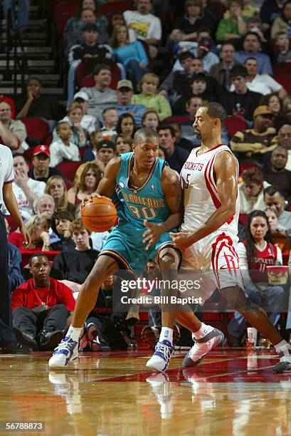 David West of the New Orleans/Oklahoma City Hornets dribbles against Juwan Howard of the Houston Rockets on January 14, 2006 at the Toyota Center in...