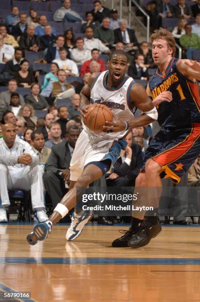 Antawn Jamison of the Washington Wizards drives to the basket against Troy Murphy of the Golden State Warriors February 8, 2006 at the MCI Center in...