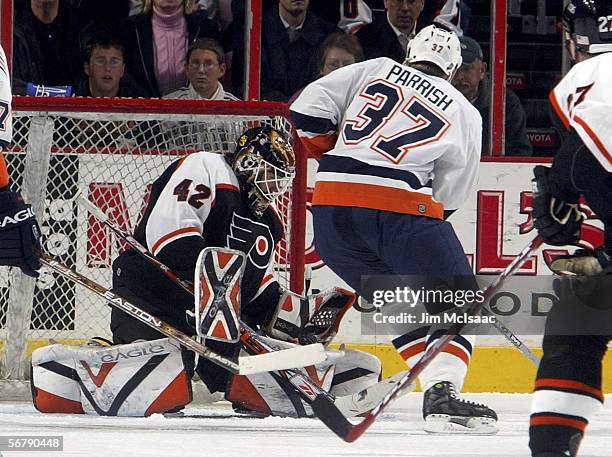 Robert Esche of the Philadelphia Flyers makes a save against Mark Parrish of the New York Islanders on February 8, 2006 at the Wachovia Center in...