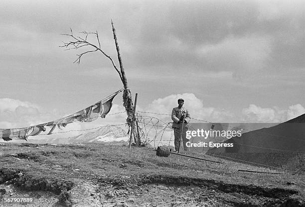 Chinese soldiers guard the border on the Nathu La mountain pass connecting India and China's Tibet Autonomous Region during the Chola incident ,...