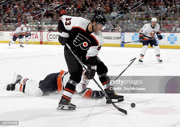 Petr Nedved of the Philadelphia Flyers skates past Brad Lukowich of the New York Islanders on February 8, 2006 at the Wachovia Center in...