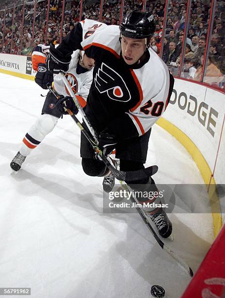 Umberger of the Philadelphia Flyers skates with the puck away from Chris Campoli of the New York Islanders on February 8, 2006 at the Wachovia Center...