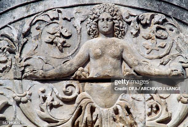 Girl emerging from acanthus leaves, detail from the bas-relief of the tympanum in front of the entrance to the temple of Hadrian, 2nd century,...