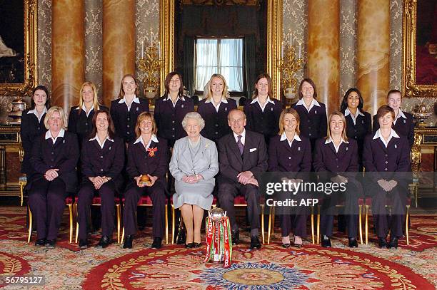 London, United Kingdom: Members of England's women's 2005 Ashes winning Cricket team sit with Britain's Queen Elizabeth II and the Duke of Edinburgh...