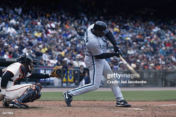 Catcher Charles Johnson of the Florida Marlins makes contact during the MLB game against the San Francisco Giants at Pacific Bell Park in San...