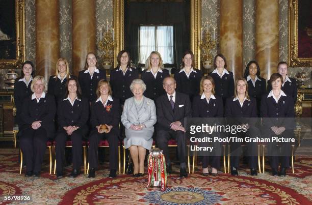 Queen Elizabeth II and the Duke of Edinburgh pose with members of England's women's 2005 Ashes winning Cricket team (Back row from left: Jo Watts,...