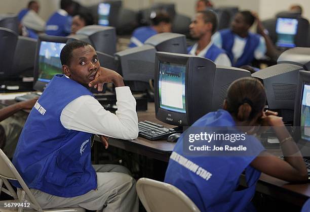 Haitian election officials rest while sitting at their computers as they wait for vote counts to arrive at the tabulation center February 9, 2005 in...