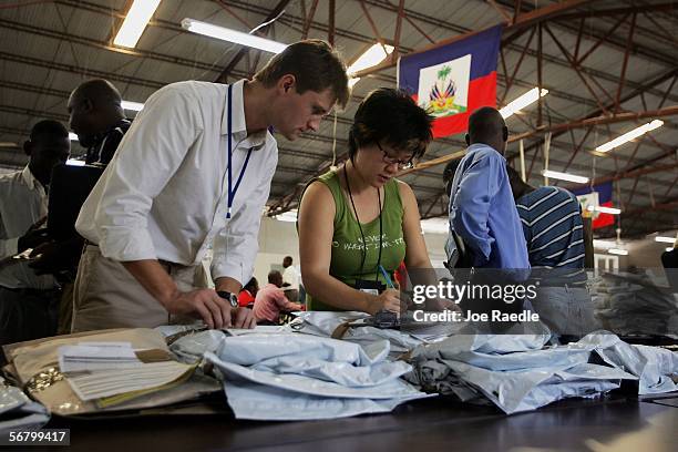 Election officials sort through vote counts as they arrive at the tabulation center February 9, 2005 in Port-au-Prince, Haiti. The vote lists trickle...