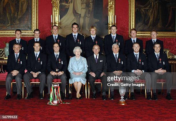 Queen Elizabeth II and the Duke of Edinburgh pose with members of England's 2005 Ashes winning Cricket team after collecting their honours at an...