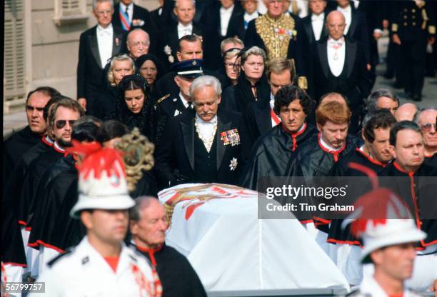 Prince Rainier, with his daughter Princess Caroline and his son Prince Albert, walks behind the coffin of his wife at the funeral of Princess Grace...