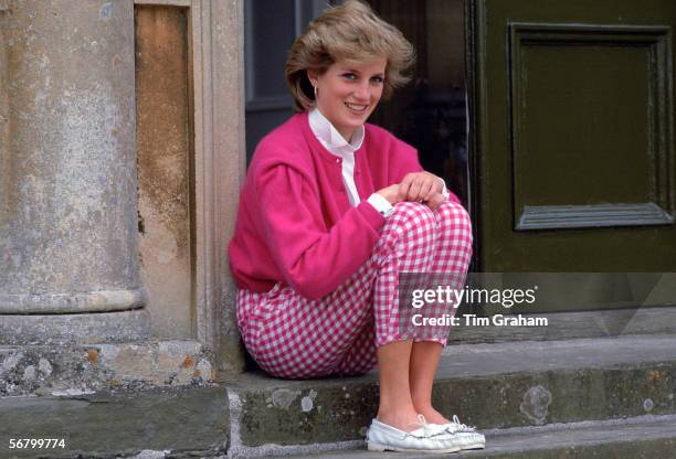 Princess Diana at home, sitting on the steps of Highgrove House.