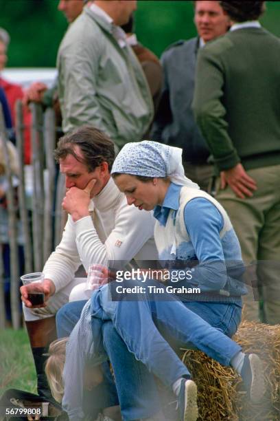 Mark Philips and Princess Anne at the Windsor Horse Show with daughter Zara Philipsplaying on her mother's lap.