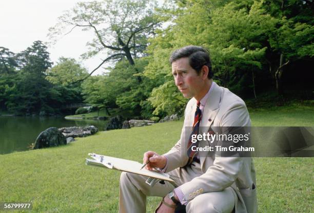Prince Charles sketching in the gardens of Omiya Palace during a break in his official tour of Japan.