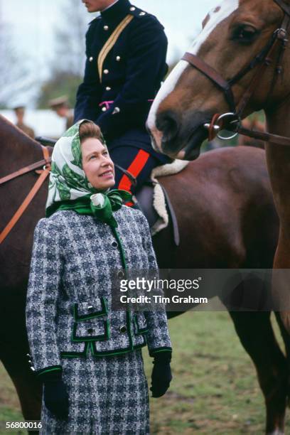 Queen Elizabeth II talks to riders at the Windsor Horse Show in the 1970s or early 1980s.