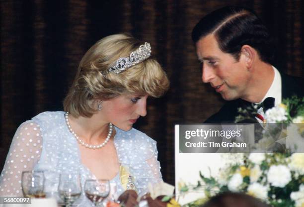 The Prince and Princess of Wales attend a banqet during their visit to New Zealand.