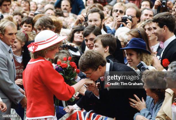 Princess Diana having her hand gallantly kissed by a student during a walkabout in Melbourne, Australia.