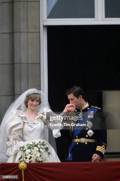 Prince Charles kisses the hand of his new bride, Princess Diana on the balcony of Buckingham Palace on their wedding day.