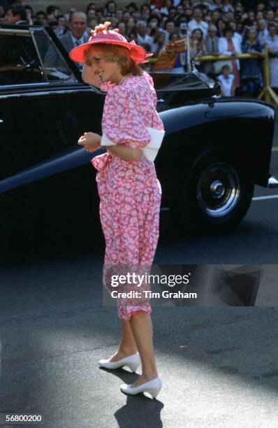 Princess Diana, Princess of Wales clutches her hat during a visit to Sydney in Australia.