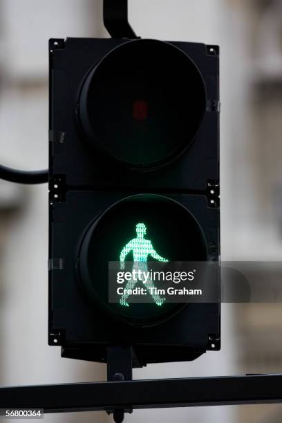 Green walk symbol on pedestrian crossing lights, London, United Kingdom.