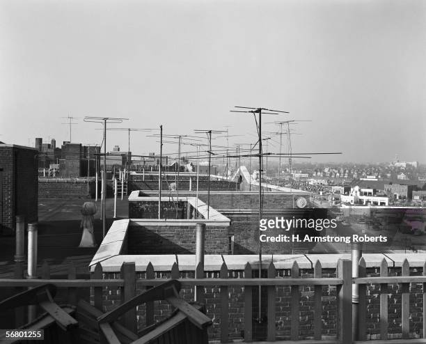 1950s: Television antennas on rooftops of buildings.