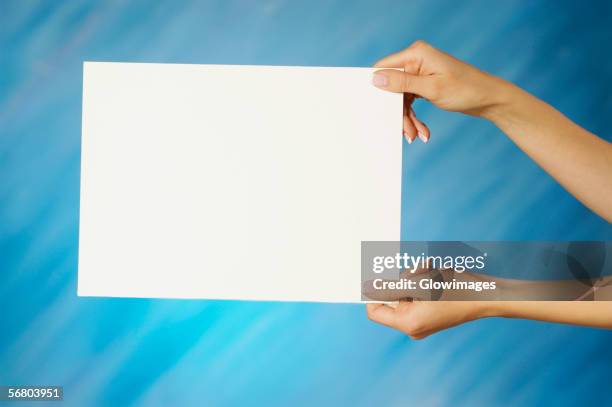 close-up of a woman's hands holding a placard - placard stock pictures, royalty-free photos & images
