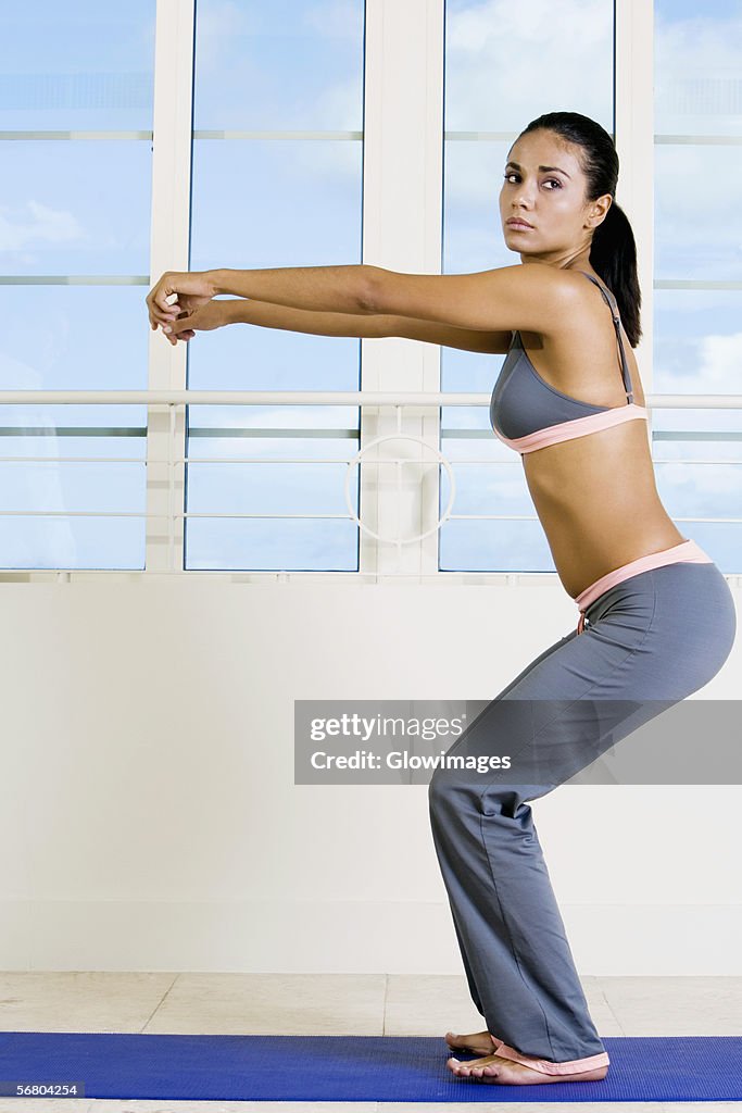 Side profile of a young woman exercising