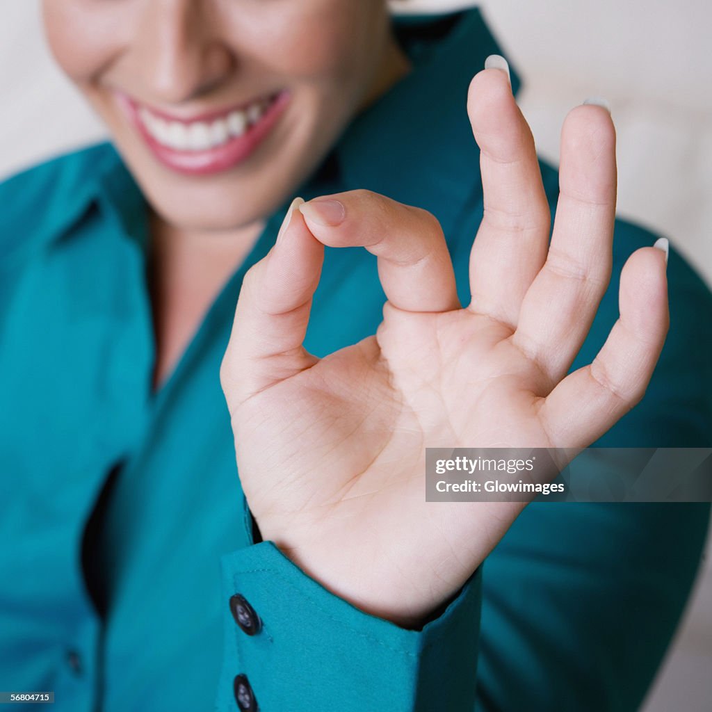 Close-up of a businesswoman making an ok sign