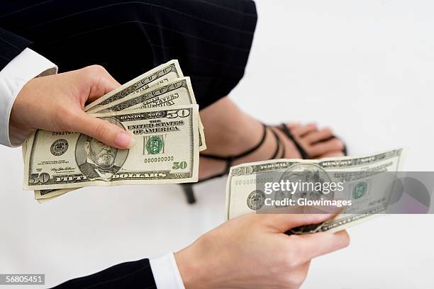 close-up of a businesswoman giving a twenty dollar bill - banconota da 20 dollari statunitensi foto e immagini stock