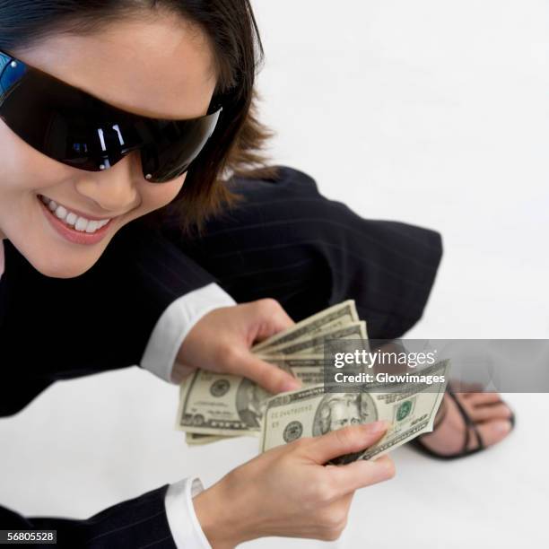 high angle view of a businesswoman holding american paper currency - 50 dollar bill stock pictures, royalty-free photos & images