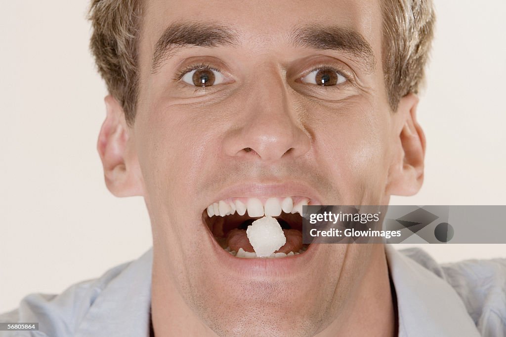 Portrait of a young man with candy in his mouth