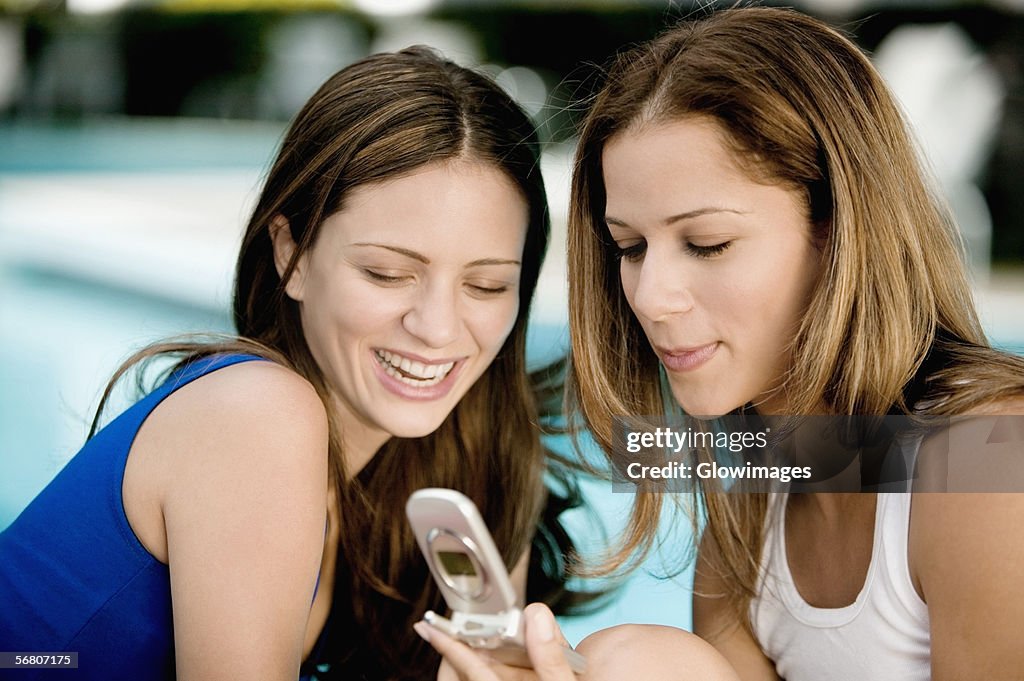 Close-up of two young women looking at a mobile phone