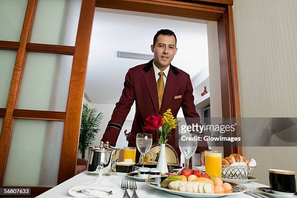 portrait of a waiter serving food - zimmerservice stock-fotos und bilder