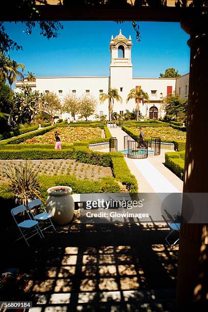 panoramic view of the facade of an ethnic building, alcazar garden, balboa park, san diego, california, usa - balboa park - fotografias e filmes do acervo