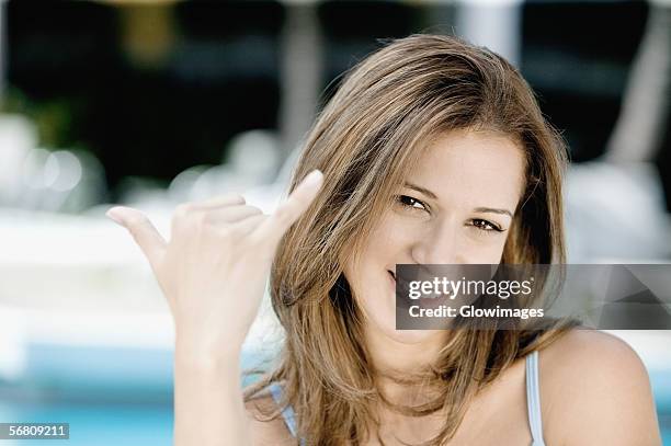 portrait of a young woman smiling - call me hand sign stock pictures, royalty-free photos & images