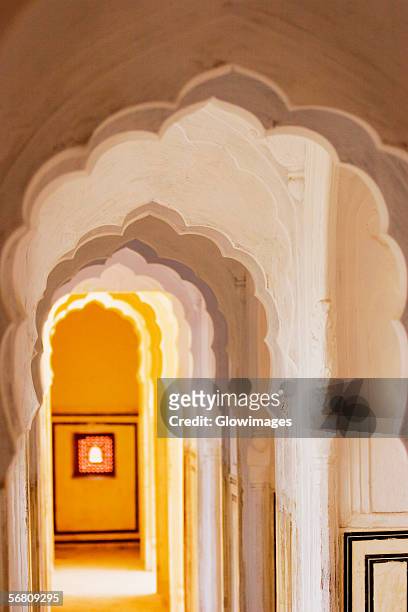 arched corridor in a palace, city palace complex, city palace, jaipur, rajasthan, india - jaipur city palace stock pictures, royalty-free photos & images