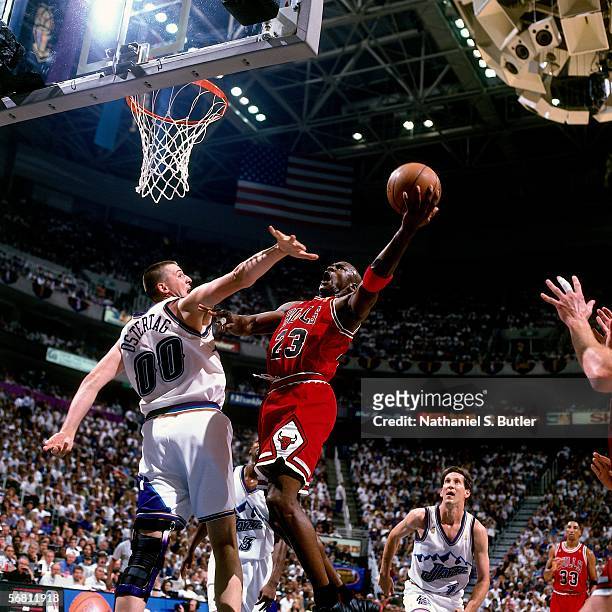 Michael Jordan of the Chicago Bulls shoots a layup against Greg Ostertag of the Utah Jazz during Game 5 of the NBA Finals on June 11, 1997 at the...
