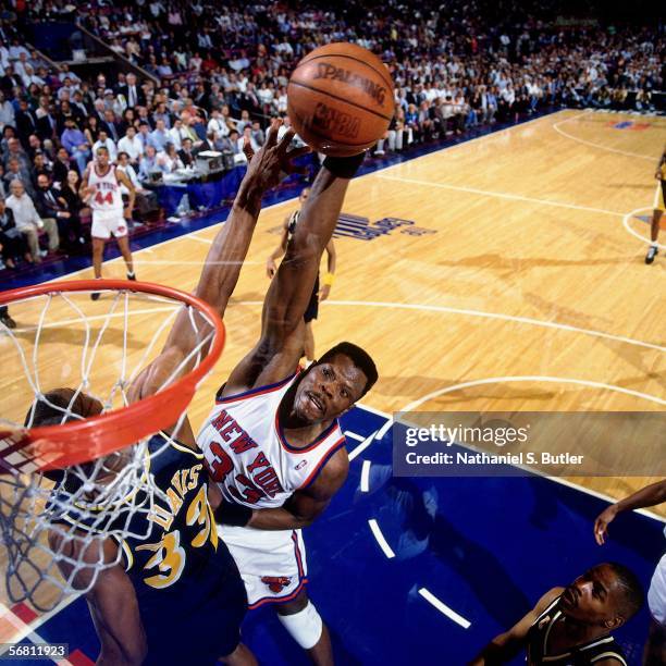 Patrick Ewing of the New York Knicks goes up for a slam dunk against Antonio Davis of the Indiana Pacers during Game 1 of the Eastern Conference...