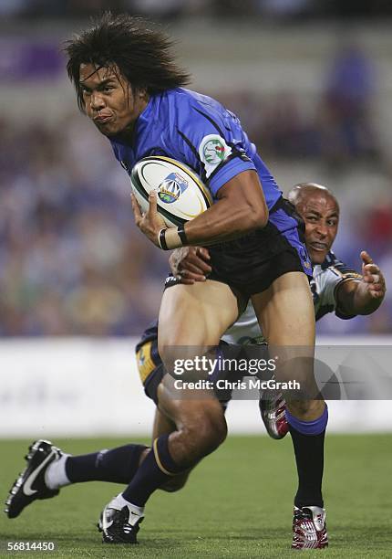 Digby Ioane of the Force is tackled by George Gregan of the Brumbies during the round one Super 14 match between the Western Force and the Brumbies...