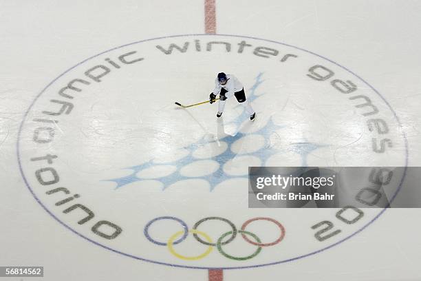 Member of the women's hockey team of Finland skates across center ice of the Torino Esposizioni hockey arena during a practice on the day of the...