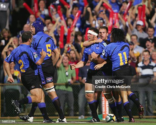 Scott Fava of the Force is congratulated by team mates after scoring the Force's first try during the round one Super 14 match between the Western...