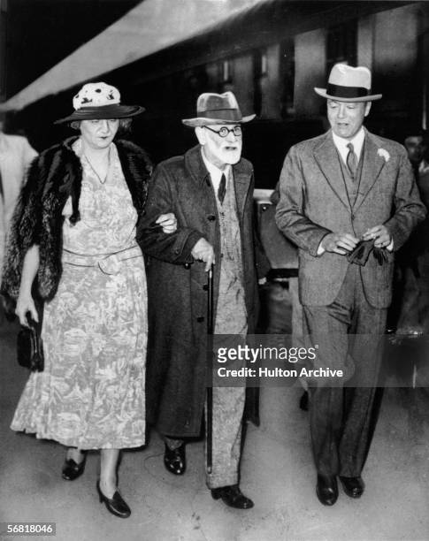 Austrian psychologist Sigmund Freud , escorted by Marie Bonaparte , a French psychoanalyst and wife of Prince George of Greece, and by American...