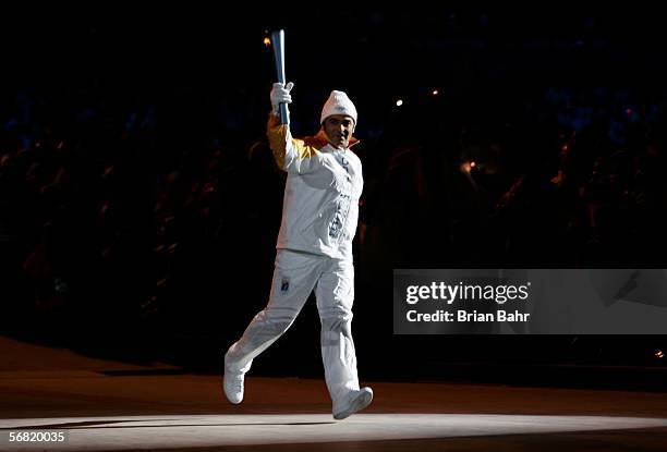 Italian down hill skier Alberto Tomba carries the Olympic flame during the Opening Ceremony of the Turin 2006 Winter Olympic Games on February 10,...