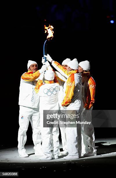 Italian skier Alberto Tomba is handed the Olympic flame during the Opening Ceremony of the Turin 2006 Winter Olympic Games on February 10, 2006 at...