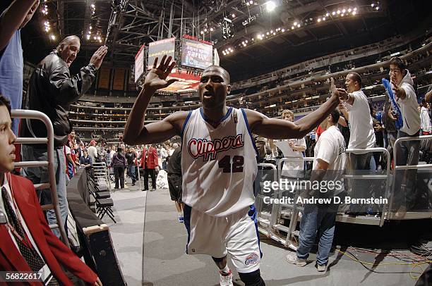 Elton Brand of the Los Angeles Clippers high fives fans after he scored forty four points against the Memphis Grizzlies on February 10, 2006 at...