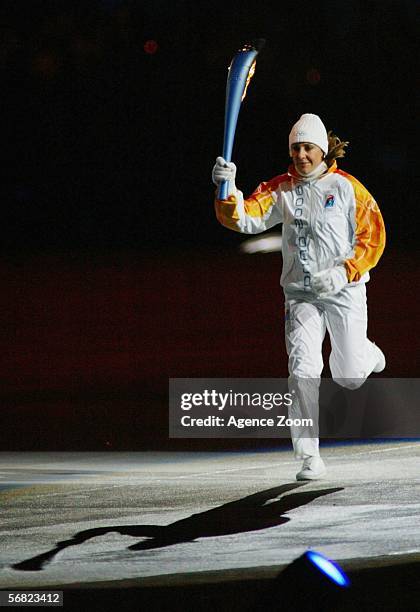 Italian skier Stefania Belmondo runs with the Olympic flame during the Opening Ceremony of the Turin 2006 Winter Olympic Games on February 10, 2006...