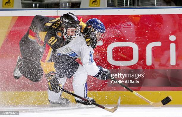 Satu Hoikkala of Finland and Maritta Becker of Germany collide during their women's ice hockey Preliminary Round Group B match during Day 1 of the...
