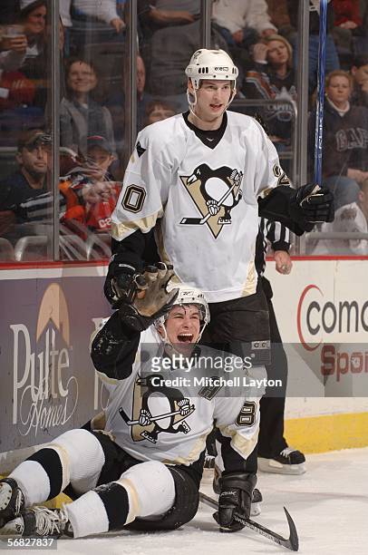 Sidney Crosby of the Pittsburgh Penguins celebrates with teammate Colby Armstrong after scoring the first goal of the game against the Washington...